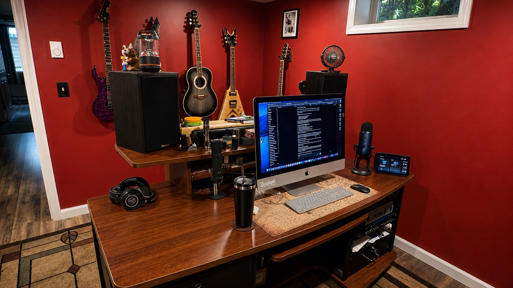 The Saundhaus recording studio with guitars, computer, microphones, and audio equipment